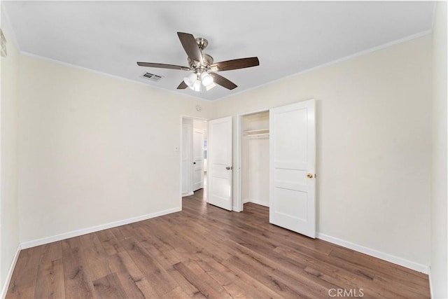 unfurnished bedroom with ceiling fan, wood-type flooring, a closet, and ornamental molding