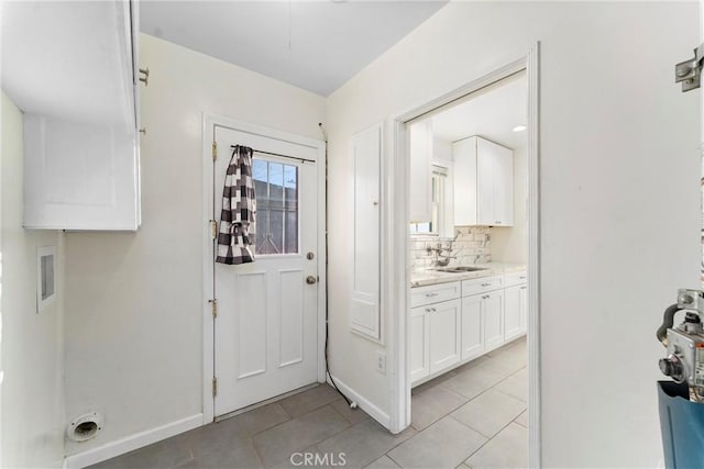 tiled foyer entrance with sink