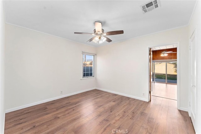 unfurnished room featuring ceiling fan, crown molding, and hardwood / wood-style flooring