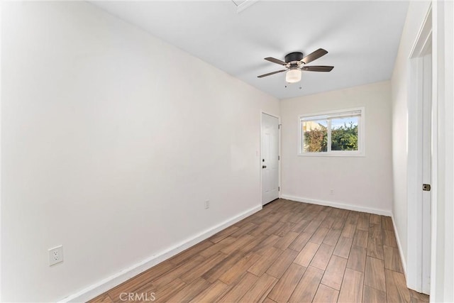 spare room with light hardwood / wood-style floors and ceiling fan