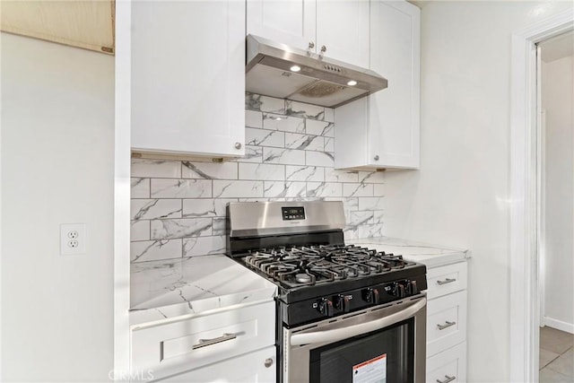 kitchen featuring decorative backsplash, light stone countertops, white cabinetry, and stainless steel range with gas stovetop