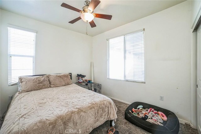 bedroom featuring carpet floors, a closet, and ceiling fan