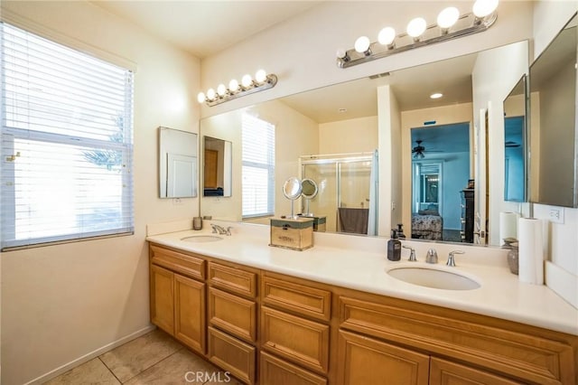 bathroom with tile patterned floors, plenty of natural light, vanity, and an enclosed shower