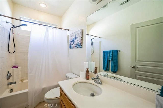 full bathroom with toilet, vanity, and shower / tub combo with curtain