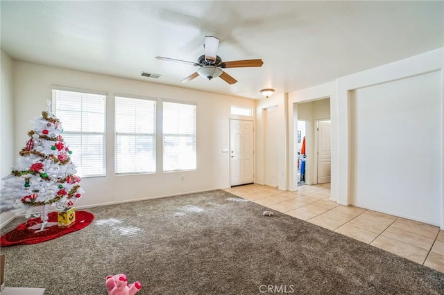 unfurnished room with ceiling fan and light colored carpet