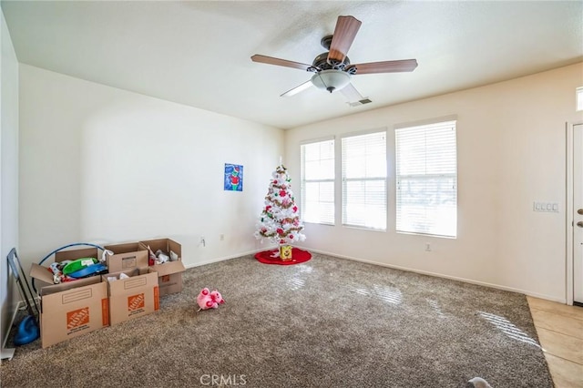 recreation room featuring ceiling fan and light colored carpet