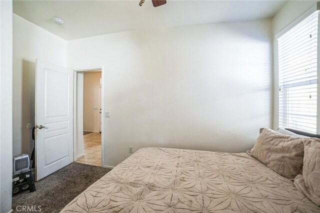 bedroom featuring ceiling fan and light tile patterned floors