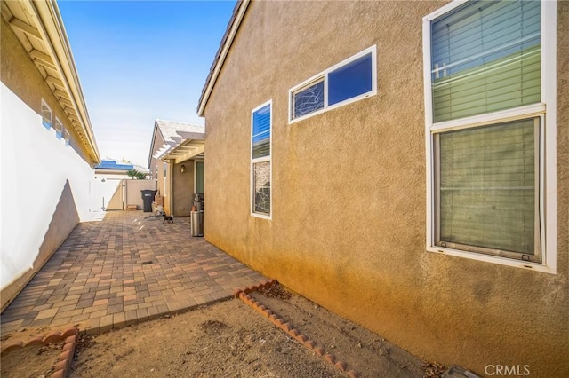 view of side of home with a patio