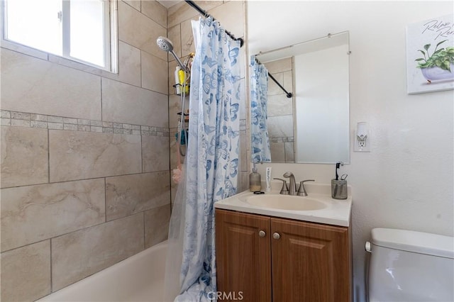 full bathroom featuring toilet, vanity, and shower / tub combo