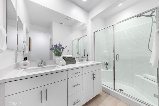 bathroom featuring tile patterned floors, vanity, and an enclosed shower