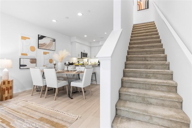 stairs with hardwood / wood-style floors