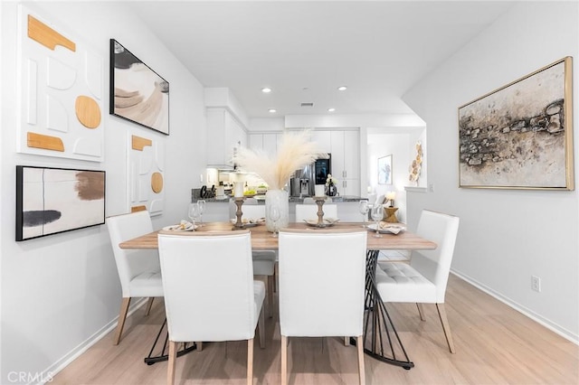 dining room with light hardwood / wood-style flooring