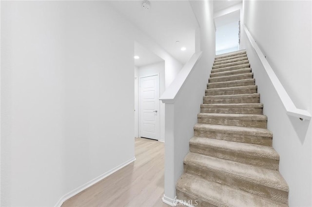 stairs featuring wood-type flooring