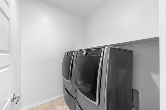 laundry room with light tile patterned floors and independent washer and dryer