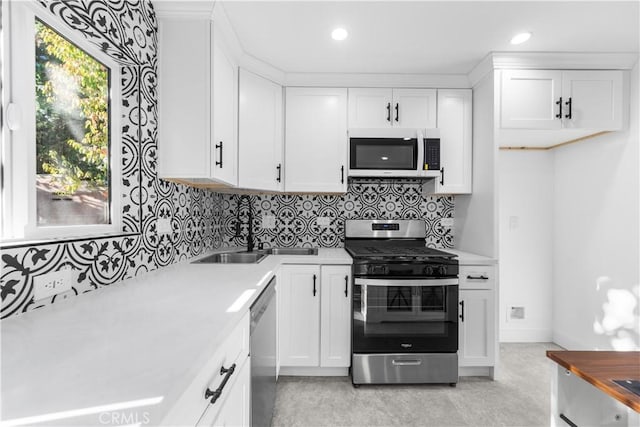 kitchen featuring white cabinets, appliances with stainless steel finishes, and sink