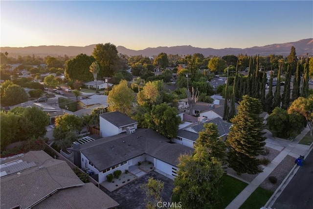 aerial view at dusk featuring a mountain view