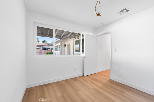 spare room featuring wood-type flooring