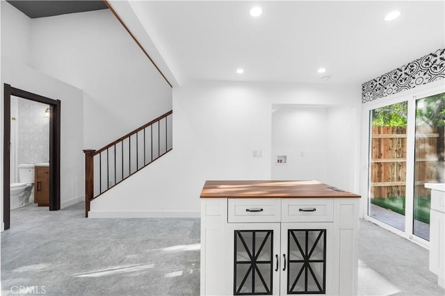 bar featuring white cabinetry, butcher block counters, and backsplash