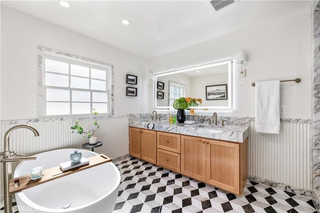 bathroom with a bath and vanity