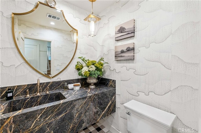 bathroom featuring sink and toilet