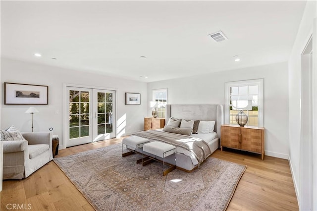 bedroom featuring french doors, access to outside, and light hardwood / wood-style flooring