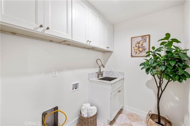 laundry area with cabinets, sink, and washer hookup