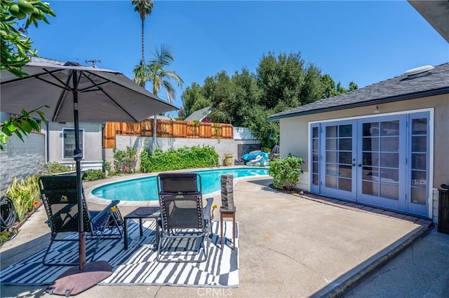 view of pool with a patio and french doors