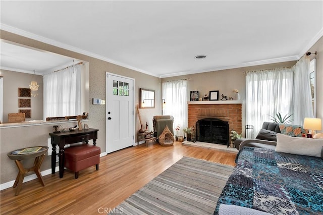 living room featuring a fireplace, crown molding, and hardwood / wood-style floors