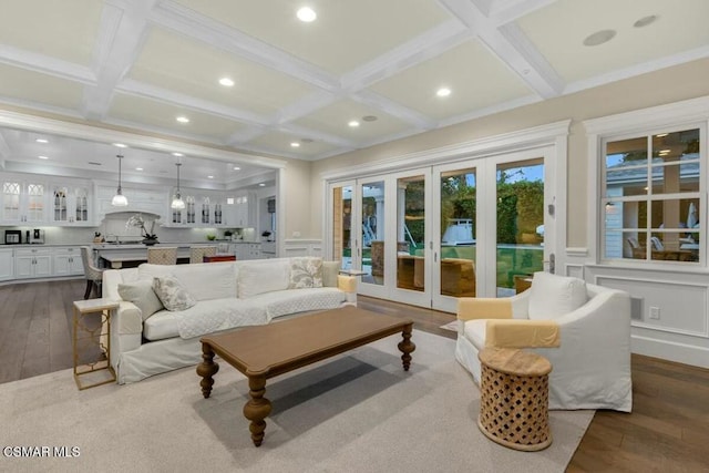 living room featuring dark hardwood / wood-style flooring, beam ceiling, and coffered ceiling