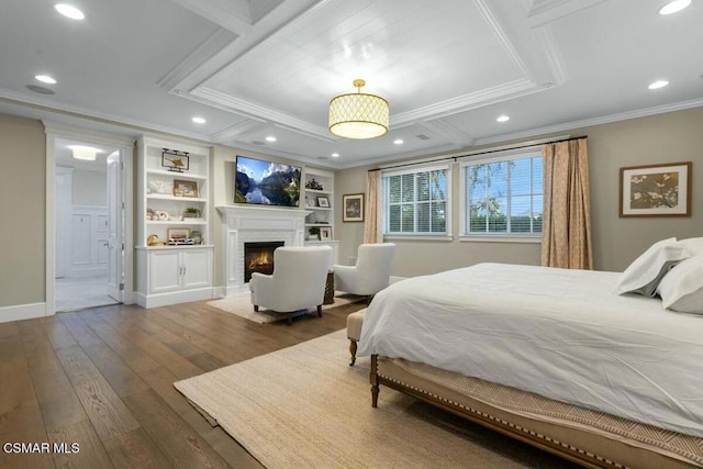 bedroom featuring a fireplace, dark hardwood / wood-style flooring, and ornamental molding