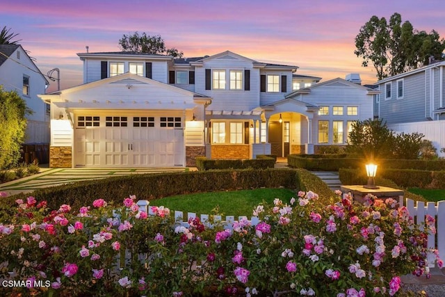 view of front of property featuring a lawn and a garage