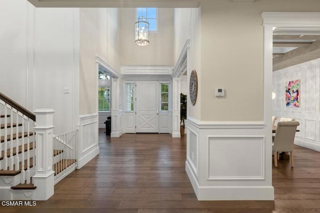 foyer entrance with a chandelier and dark hardwood / wood-style floors