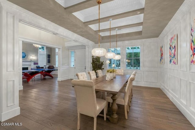 dining area featuring a tray ceiling, dark hardwood / wood-style floors, and an inviting chandelier