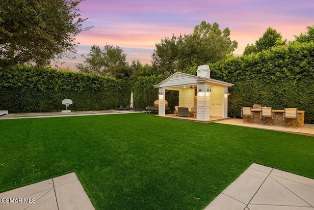 yard at dusk with a patio