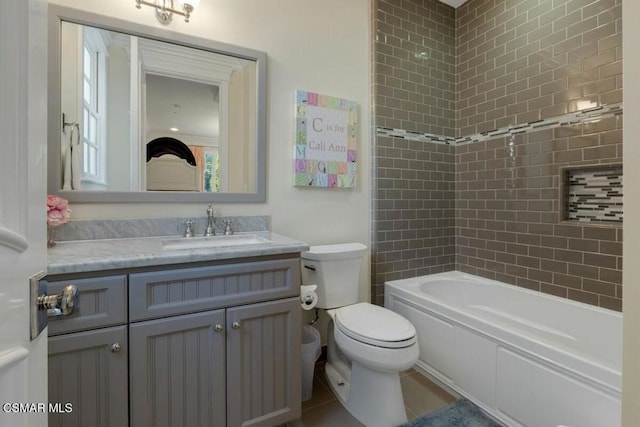 full bathroom featuring toilet, tiled shower / bath combo, and vanity