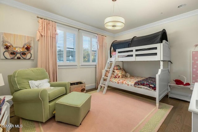 bedroom with dark hardwood / wood-style floors and crown molding