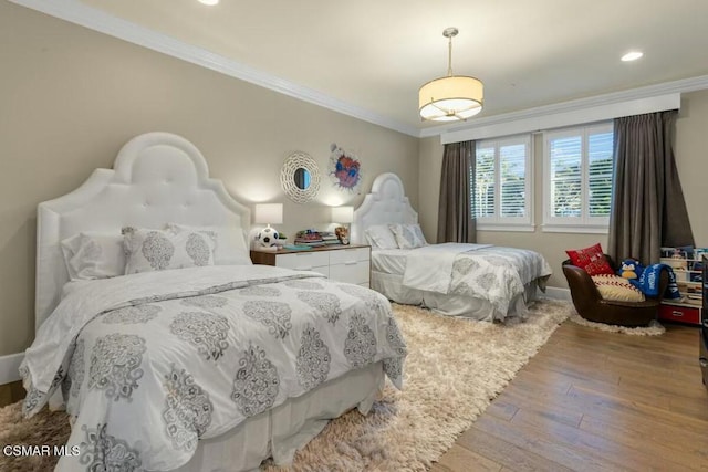 bedroom featuring crown molding and hardwood / wood-style floors