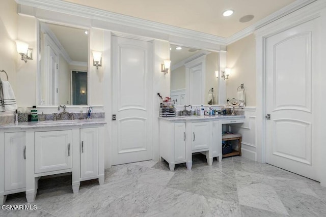 bathroom with ornamental molding and vanity