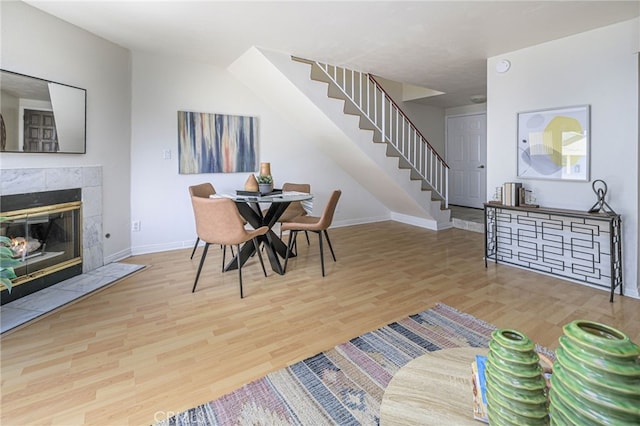 dining area featuring a fireplace and wood-type flooring