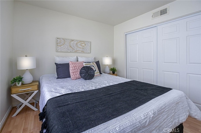 bedroom with a closet and hardwood / wood-style floors