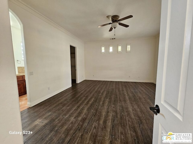 unfurnished room with ceiling fan, dark hardwood / wood-style floors, and ornamental molding