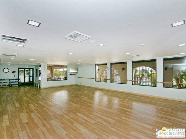 exercise room featuring light hardwood / wood-style floors