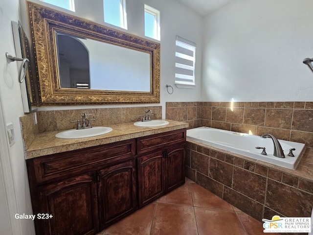 bathroom featuring vanity, tile patterned floors, and a relaxing tiled tub