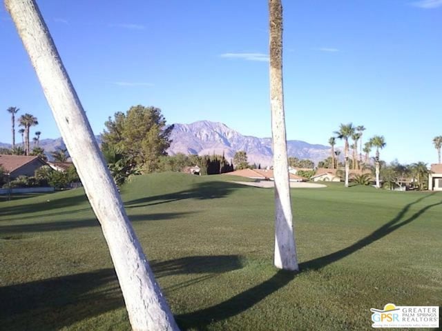 view of property's community featuring a mountain view and a lawn