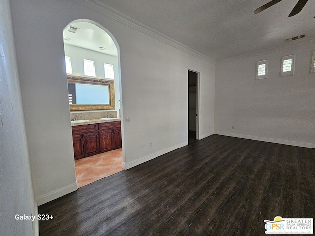 unfurnished room featuring ceiling fan, crown molding, hardwood / wood-style floors, and sink