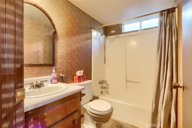 full bathroom with shower / bath combo with shower curtain, toilet, and vanity