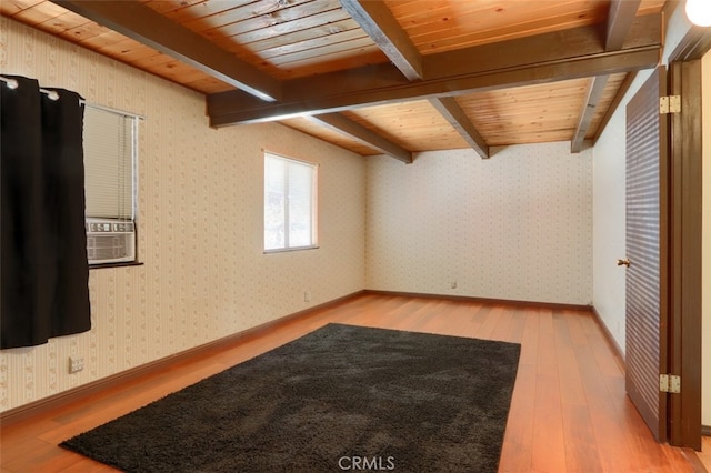 additional living space featuring hardwood / wood-style flooring, beamed ceiling, and wood ceiling