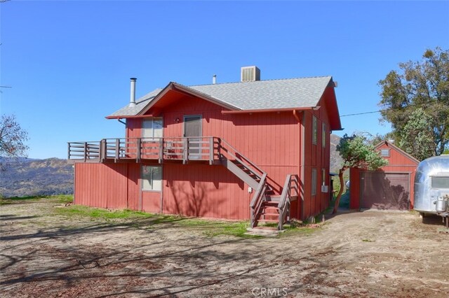 back of house with a deck