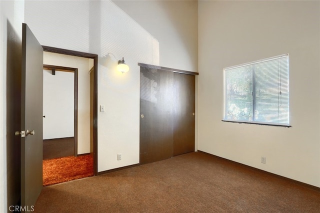 unfurnished bedroom featuring carpet and a closet