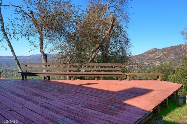 wooden deck with a mountain view